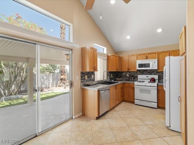 7924 Mcdowell Dr, Las Vegas, NV 89129 - kitchen with white appliances, tasteful backsplash, light tile patterned floors, ceiling fan, and lofted ceiling