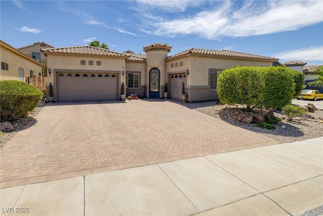 1329 Calle Cantar, Henderson, NV 89012 - mediterranean / spanish-style home with an attached garage, stucco siding, decorative driveway, and a tiled roof