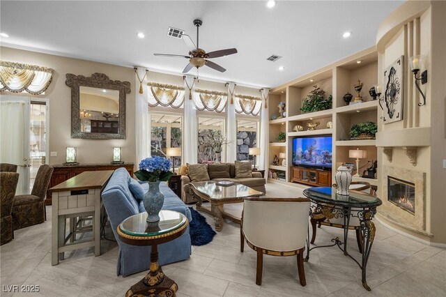1329 Calle Cantar, Henderson, NV 89012 - living area featuring ceiling fan, a premium fireplace, built in shelves, and recessed lighting