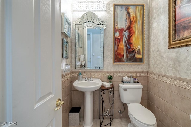 1329 Calle Cantar, Henderson, NV 89012 - half bathroom featuring wainscoting, tile patterned floors, and tile walls