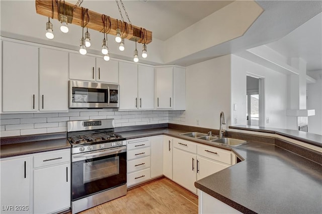 483 Marina Cv, Boulder City, NV 89005 - kitchen featuring appliances with stainless steel finishes, dark countertops, and decorative backsplash