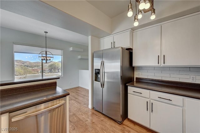483 Marina Cv, Boulder City, NV 89005 - kitchen featuring stainless steel fridge, dark countertops, a chandelier, tasteful backsplash, and white cabinets