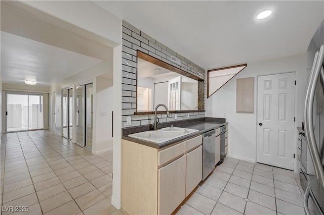 483 Marina Cv, Boulder City, NV 89005 - kitchen featuring appliances with stainless steel finishes, light tile patterned floors, dark countertops, and tasteful backsplash