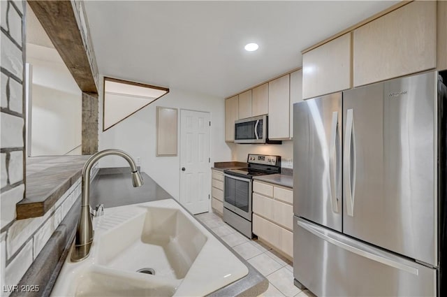 483 Marina Cv, Boulder City, NV 89005 - kitchen featuring appliances with stainless steel finishes, light tile patterned floors, light brown cabinets, recessed lighting, and cream cabinets