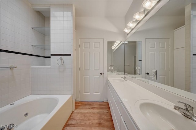 483 Marina Cv, Boulder City, NV 89005 - bathroom featuring a tub with jets, wood finished floors, and double vanity
