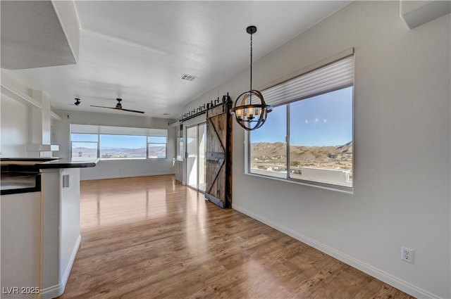 483 Marina Cv, Boulder City, NV 89005 - unfurnished dining area featuring a chandelier, ceiling fan, and wood finished floors