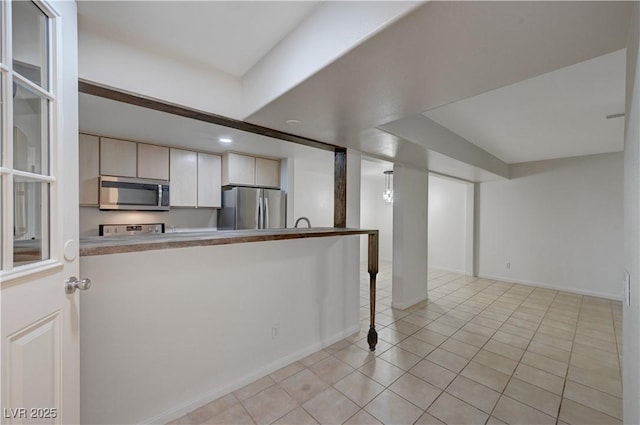 483 Marina Cv, Boulder City, NV 89005 - kitchen with appliances with stainless steel finishes, light tile patterned floors, and a peninsula