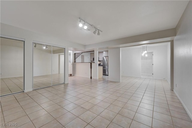 483 Marina Cv, Boulder City, NV 89005 - finished basement with freestanding refrigerator, light tile patterned floors, and rail lighting