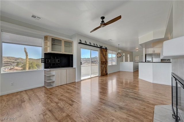 483 Marina Cv, Boulder City, NV 89005 - unfurnished living room featuring a ceiling fan and light wood-type flooring