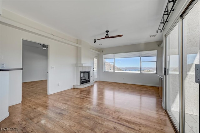 483 Marina Cv, Boulder City, NV 89005 - unfurnished living room featuring ceiling fan, light wood-type flooring, and a tile fireplace