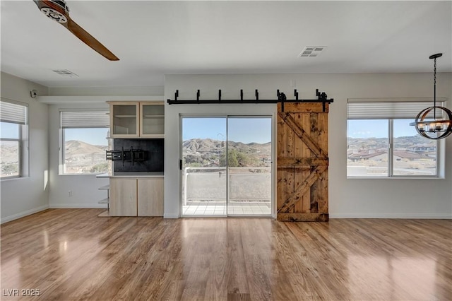 483 Marina Cv, Boulder City, NV 89005 - unfurnished living room with wood finished floors, plenty of natural light, and a chandelier