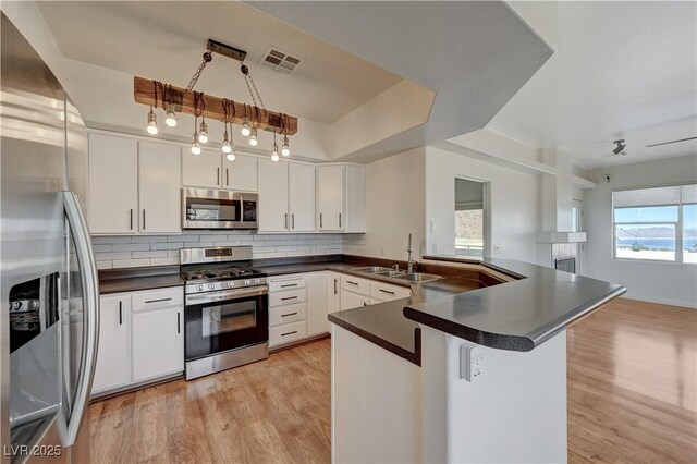 483 Marina Cv, Boulder City, NV 89005 - kitchen with appliances with stainless steel finishes, dark countertops, decorative backsplash, and light wood-type flooring