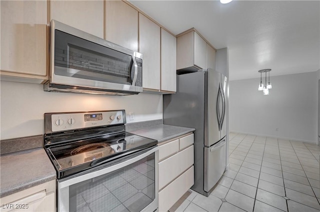 483 Marina Cv, Boulder City, NV 89005 - kitchen featuring stainless steel appliances, light countertops, light tile patterned flooring, and decorative light fixtures
