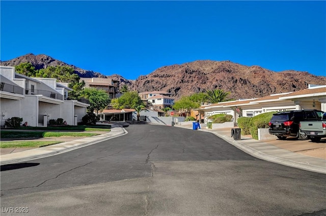 483 Marina Cv, Boulder City, NV 89005 - view of asphalt road with a mountain view, sidewalks, a residential view, and curbs