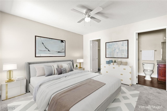 6800 E Lake Mead Blvd Unit 1018, Las Vegas, NV 89156 - bedroom featuring light carpet, ensuite bathroom, and a ceiling fan