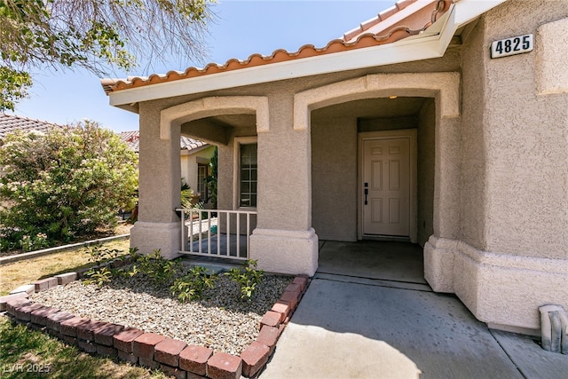 4825 White Aspen Ave, Las Vegas, NV 89130 - doorway to property featuring stucco siding and a tile roof