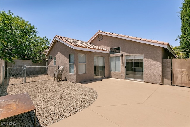 4825 White Aspen Ave, Las Vegas, NV 89130 - rear view of house with a gate, stucco siding, a patio, and a tiled roof
