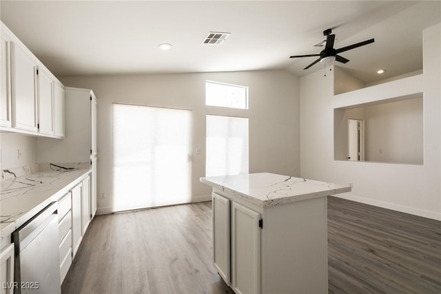 4825 White Aspen Ave, Las Vegas, NV 89130 - kitchen with lofted ceiling, stainless steel dishwasher, wood finished floors, a center island, and a ceiling fan