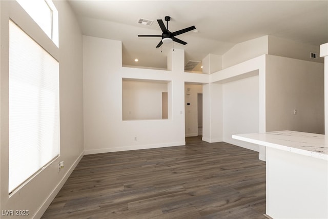 4825 White Aspen Ave, Las Vegas, NV 89130 - unfurnished living room featuring a ceiling fan, dark wood-style floors, and vaulted ceiling