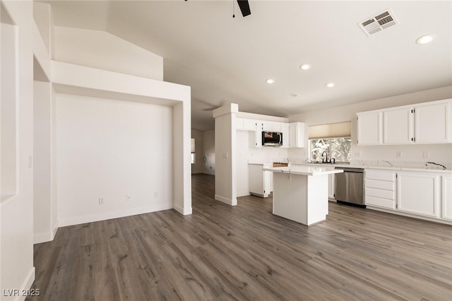 4825 White Aspen Ave, Las Vegas, NV 89130 - kitchen with appliances with stainless steel finishes, a center island, recessed lighting, white cabinetry, and dark wood-type flooring