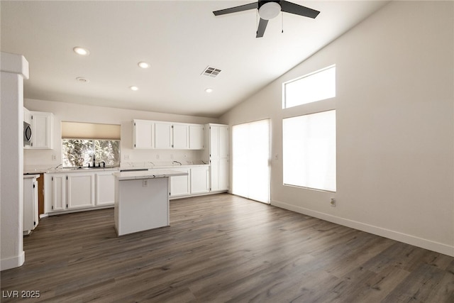 4825 White Aspen Ave, Las Vegas, NV 89130 - kitchen featuring a center island, white cabinets, healthy amount of natural light, light countertops, and recessed lighting