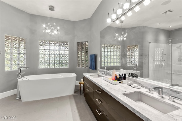 5680 N Fort Apache Rd, Las Vegas, NV 89149 - full bathroom with a chandelier, a freestanding tub, a shower stall, and double vanity