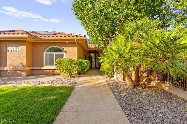 5680 N Fort Apache Rd, Las Vegas, NV 89149 - view of front of property with solar panels, stucco siding, and a tile roof