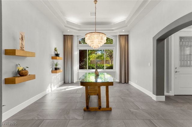 5680 N Fort Apache Rd, Las Vegas, NV 89149 - dining room with arched walkways, a chandelier, and a tray ceiling