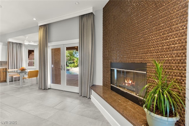 5680 N Fort Apache Rd, Las Vegas, NV 89149 - unfurnished living room with french doors, an accent wall, recessed lighting, ornamental molding, and a glass covered fireplace