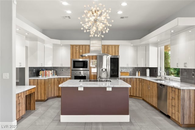 5680 N Fort Apache Rd, Las Vegas, NV 89149 - kitchen with appliances with stainless steel finishes, island exhaust hood, decorative backsplash, modern cabinets, and recessed lighting