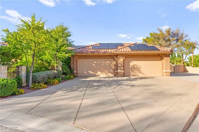 5680 N Fort Apache Rd, Las Vegas, NV 89149 - view of front facade featuring stucco siding, concrete driveway, roof mounted solar panels, and an attached garage