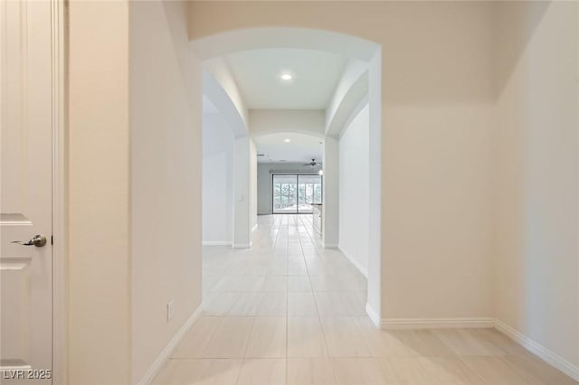8732 Kendall Brook Cir, Las Vegas, NV 89149 - hallway featuring arched walkways, light tile patterned flooring, and recessed lighting