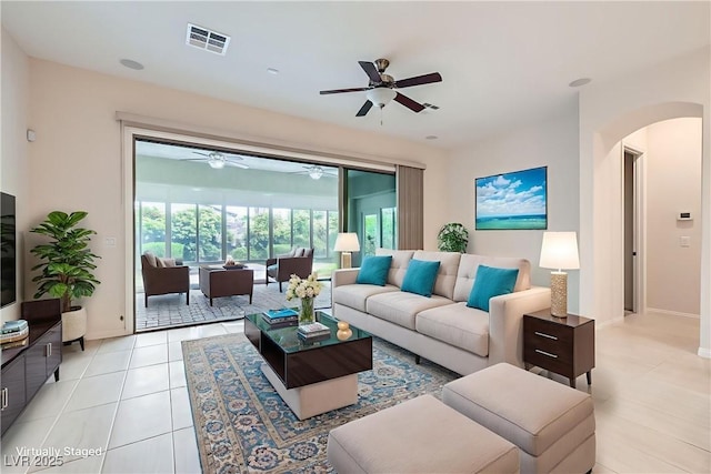 8732 Kendall Brook Cir, Las Vegas, NV 89149 - living area featuring arched walkways, ceiling fan, and light tile patterned flooring