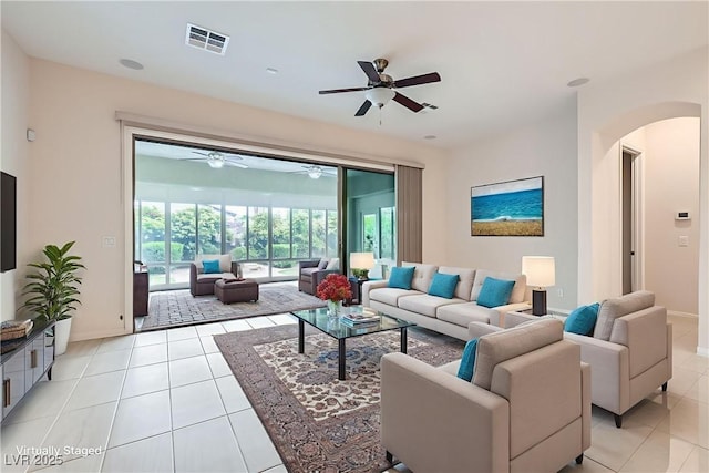 8732 Kendall Brook Cir, Las Vegas, NV 89149 - living room with arched walkways, light tile patterned floors, and ceiling fan
