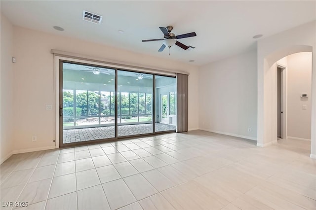 8732 Kendall Brook Cir, Las Vegas, NV 89149 - empty room with ceiling fan, arched walkways, and light tile patterned floors