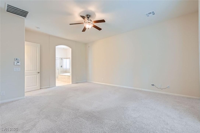 8732 Kendall Brook Cir, Las Vegas, NV 89149 - unfurnished room featuring a ceiling fan, arched walkways, and light colored carpet