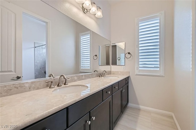 8732 Kendall Brook Cir, Las Vegas, NV 89149 - full bathroom featuring double vanity and baseboards