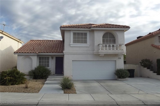 8704 Autumn Wreath Ave, Las Vegas, NV 89129 - mediterranean / spanish-style home featuring concrete driveway, a garage, a tiled roof, and stucco siding