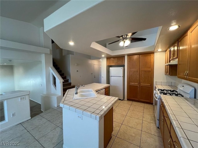 8704 Autumn Wreath Ave, Las Vegas, NV 89129 - kitchen with tile countertops, white appliances, ceiling fan, under cabinet range hood, and recessed lighting