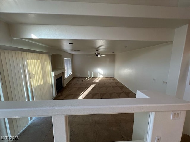 8704 Autumn Wreath Ave, Las Vegas, NV 89129 - unfurnished living room featuring a ceiling fan and a fireplace