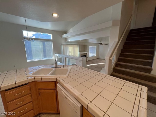 8704 Autumn Wreath Ave, Las Vegas, NV 89129 - kitchen featuring tile countertops, white dishwasher, a fireplace, lofted ceiling, and open floor plan