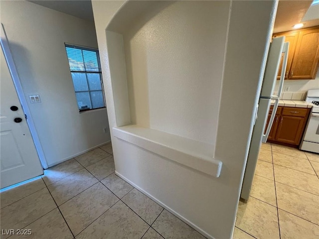 8704 Autumn Wreath Ave, Las Vegas, NV 89129 - corridor with light tile patterned floors