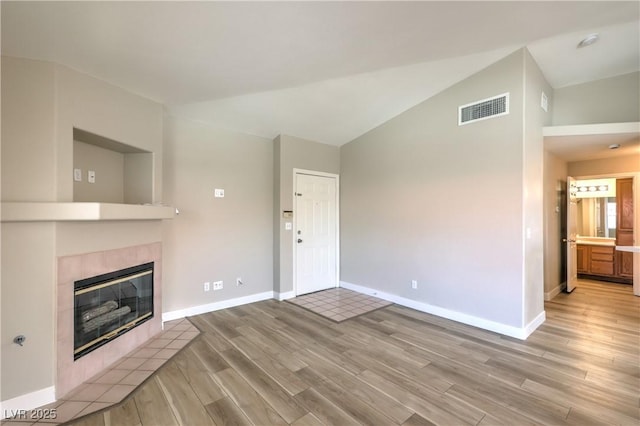 370 Manti Pl Unit 21, Henderson, NV 89014 - unfurnished living room with light wood finished floors, a fireplace, and lofted ceiling