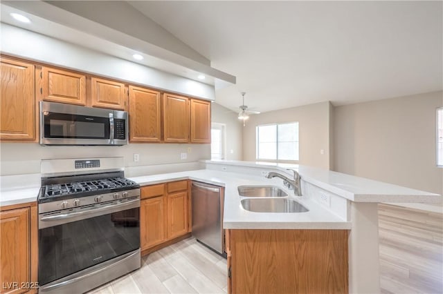 370 Manti Pl Unit 21, Henderson, NV 89014 - kitchen featuring appliances with stainless steel finishes, a peninsula, vaulted ceiling, light countertops, and ceiling fan