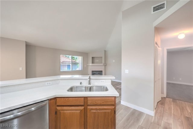 370 Manti Pl Unit 21, Henderson, NV 89014 - kitchen featuring stainless steel dishwasher, open floor plan, light wood-style flooring, light countertops, and lofted ceiling