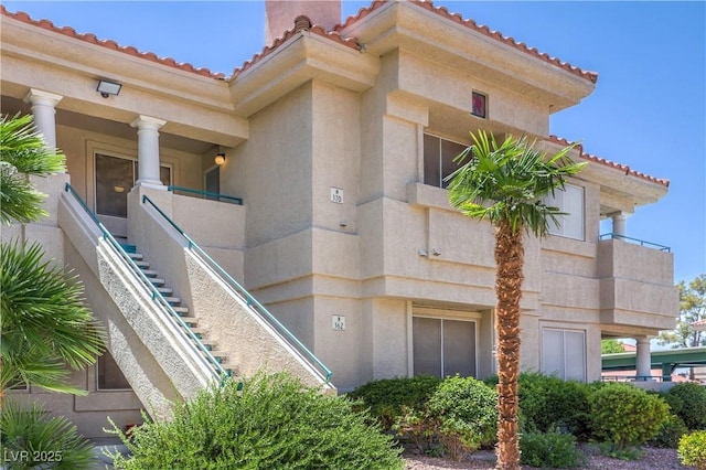 370 Manti Pl Unit 21, Henderson, NV 89014 - view of side of home with a tile roof, stucco siding, and stairs