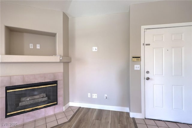 370 Manti Pl Unit 21, Henderson, NV 89014 - unfurnished living room with a tiled fireplace and wood finished floors