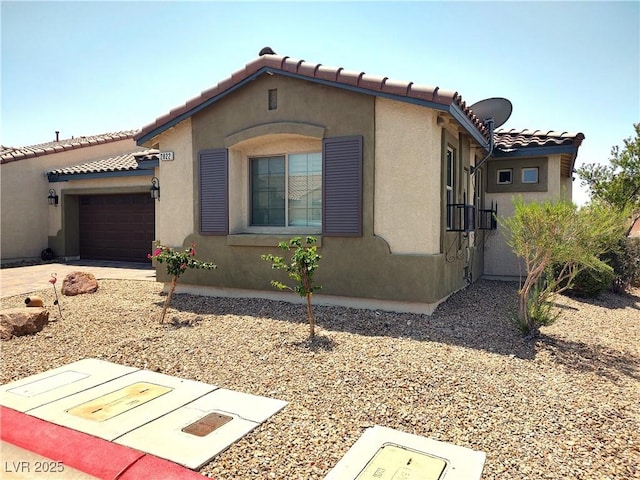 2822 Chetco River St, Laughlin, NV 89029 - mediterranean / spanish-style house with a garage, stucco siding, a tile roof, and concrete driveway