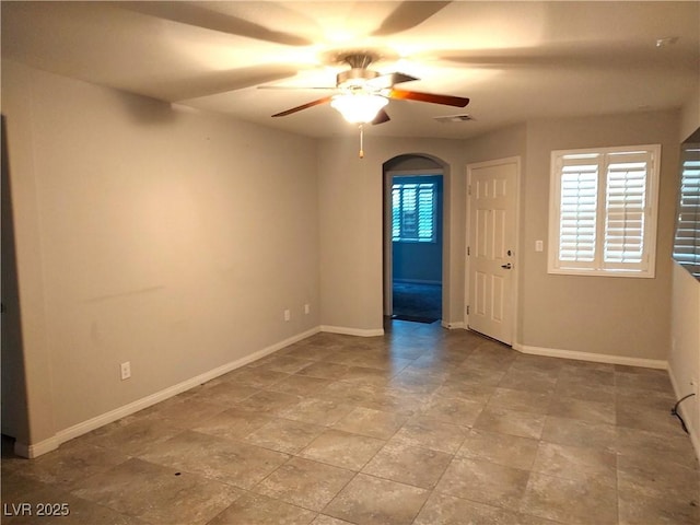 2822 Chetco River St, Laughlin, NV 89029 - unfurnished room with ceiling fan, stone finish flooring, and arched walkways