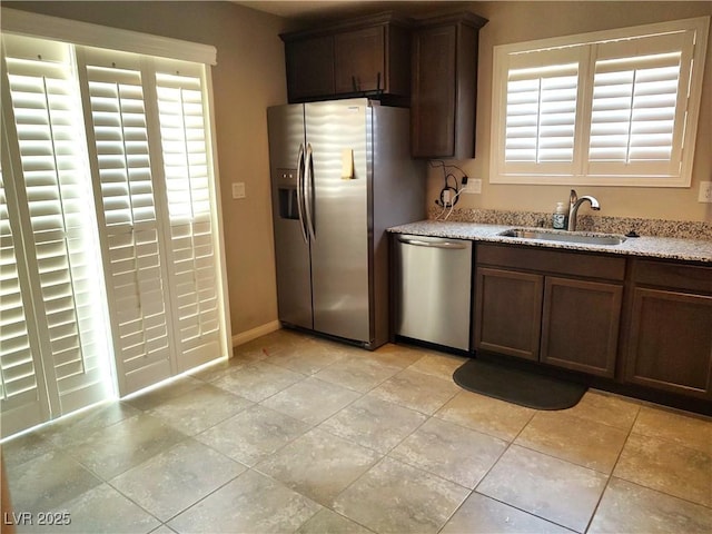 2822 Chetco River St, Laughlin, NV 89029 - kitchen featuring appliances with stainless steel finishes and light stone countertops